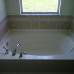 STAND ALONE SOAKER TUB WITH ROWS OF ACCENT TILE