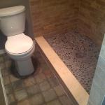 BEIGE MARBLE CURB WITH STONE PEBBLE MOSAIC WITH SILVER GRAY GROUT