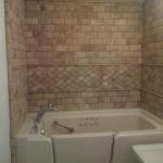 WALK  IN TUB WITH SUBWAY TRAVERTINE TILE BEVELED AND MOSAIC ACCENT STRIP