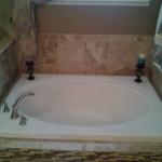 NEW SOAKER TUB WITH NEW TILE SURROUND