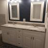 New Classic white cabinets with ship lap accent wall and framed mirrors and lights centered per undermount sink with custom Granite..
